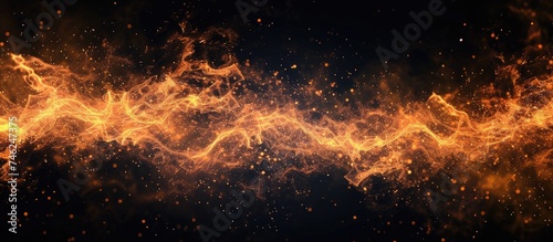 Fiery sparks isolated on a black background create abstract flaming patterns in a close-up view, representing the concept of energy.