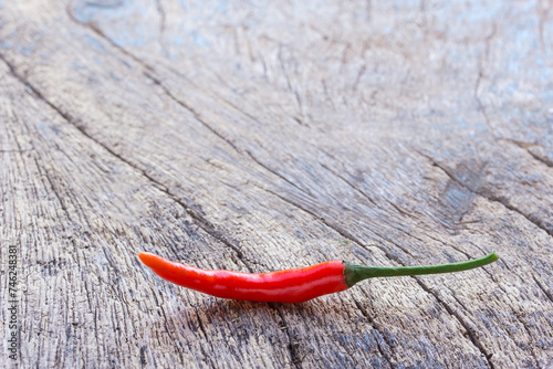 Fresh red chili on an old wooden background.