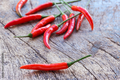 Fresh red chili on an old wooden background.