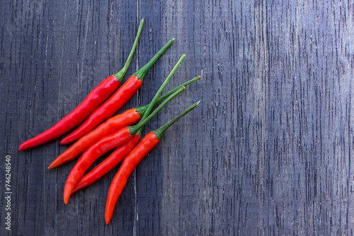 Fresh red chili on an old wooden background.