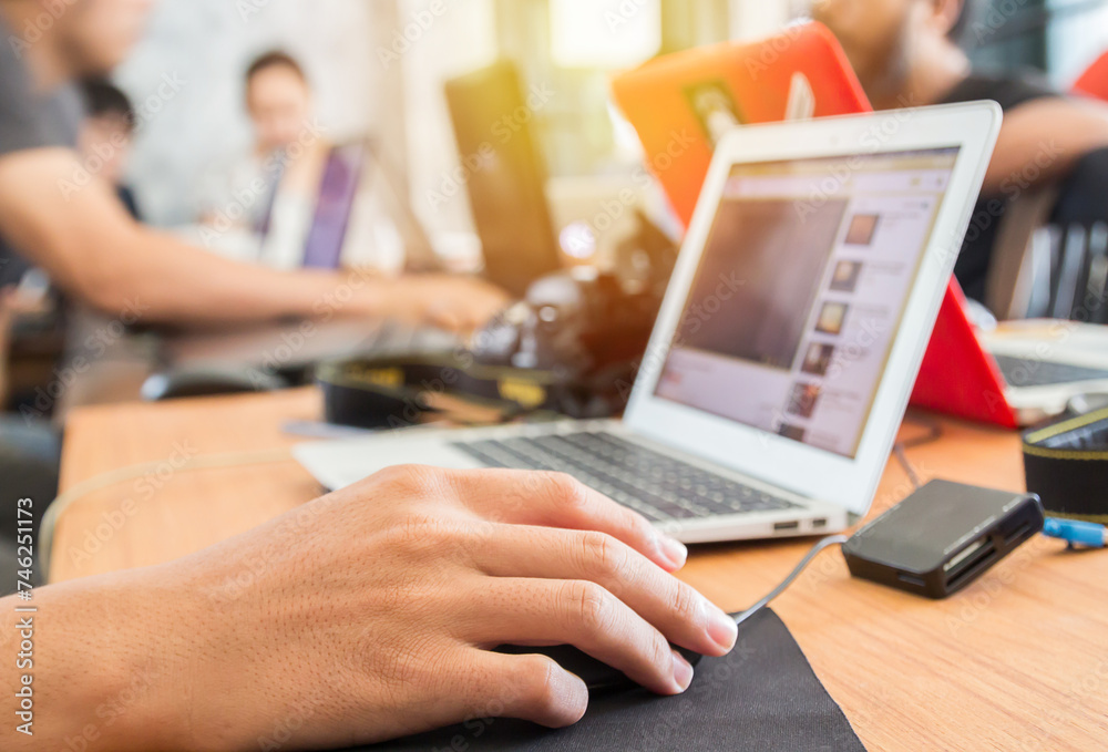 Young adult business man typing using laptop in office workplace. Young adult business man typing using laptop in office workplace.
