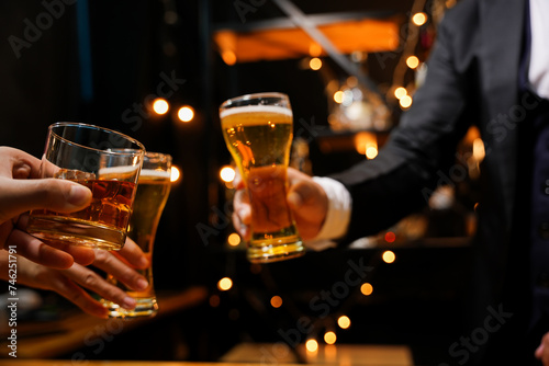 food and drink male friends are happy drinking beer and clinking glasses at a bar or pub.
