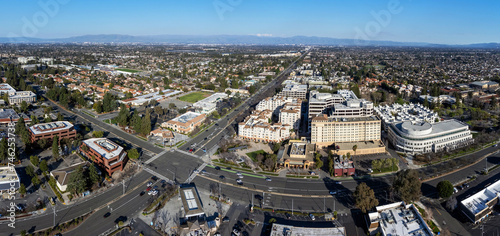 Aerial panoramic view of city center of Cupertino, California. Intersection of Stevens Creek Blvd and De Anza Blvd. Silicon Valley skyline.  photo