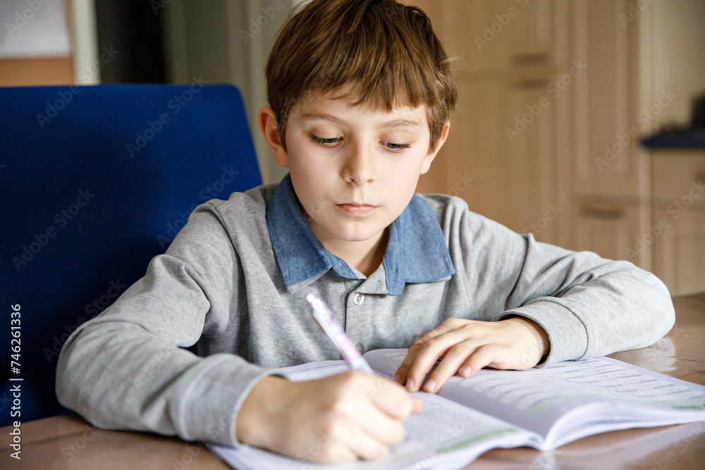 Upset school kid boy making homework during quarantine time from corona pandemic disease. Crying and sad boy frustrating staying at home. Upset school kid boy making homework during quarantine time from corona pandemic disease. Crying and sad boy frustrating staying at home.