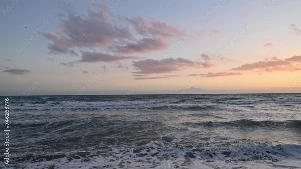 Cloudy sunset with sea waves close to shore Cloudy sunset with sea waves close to shore