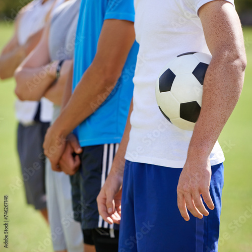 Field, team and hand holding soccer ball for game, training and competition with fitness. People, group and football player with anthem, captain or leader for sports, exercise or workout for contest