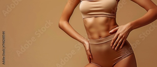 Isolated on a khaki backdrop is a picture of a perfect feminine physique with waist-touching fat cells and cellulite.