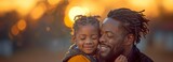 A happy African American youngster with a happy father, who is smiling and closing his eyes as they enjoy themselves.
