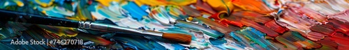 A painters palette with vibrant oil paints brush in motion close up