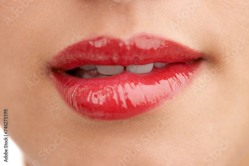 Person, red lipstick and closeup of mouth with makeup for cosmetics, gloss or glow in treatment. Colorful lips of woman or model with bite in satisfaction for mouth, oral or beauty in cosmetology