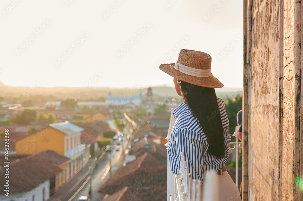 Young woman enjoying a view of the skyline of Granada in Nicaragua during sunset