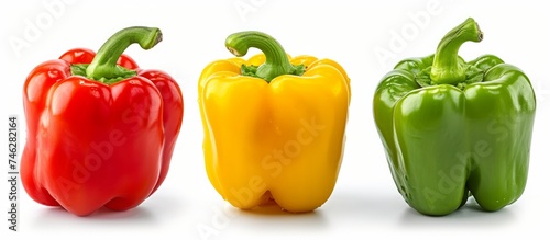 Vibrant and colorful composition of three red peppers and one yellow bell pepper