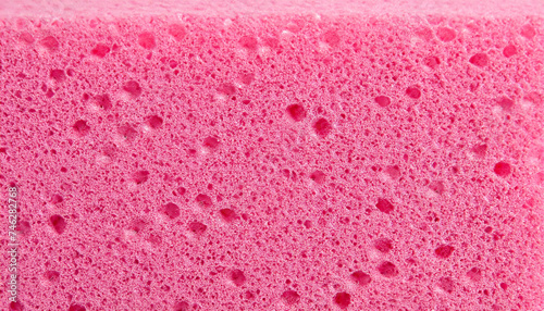 Texture of a porous pink sponge close up. Cellulose pink sponge. micro plastic made from foam