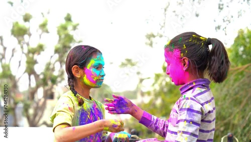 Cheerful young kids celebrating Holi festival, kids playing with colors during Holi Color festival photo
