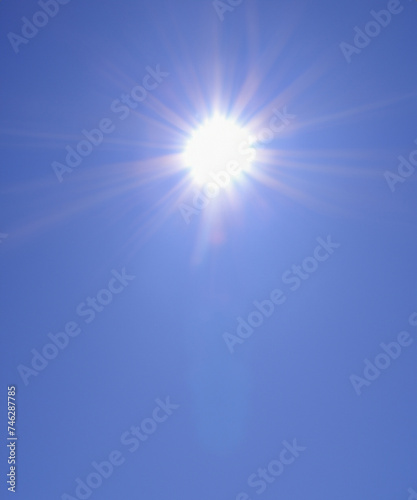 Sunbeam through the haze on blue sky, vertical