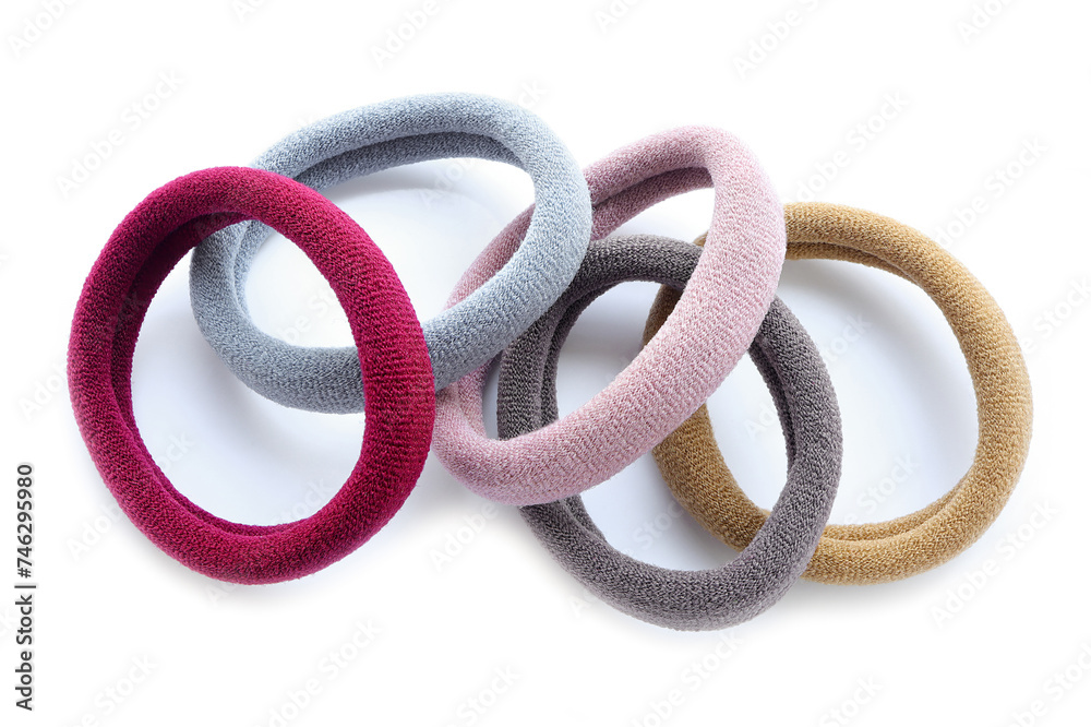 Multi-colored hair ties on white background on white background. Top view. Multicolored elastics, comfortable elastic bands for hair Multi-colored hair ties on white background on white background. Top view. Multicolored elastics, comfortable elastic bands for hair