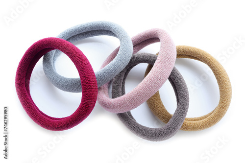 Multi-colored hair ties on white background on white background. Top view. Multicolored elastics, comfortable elastic bands for hair 