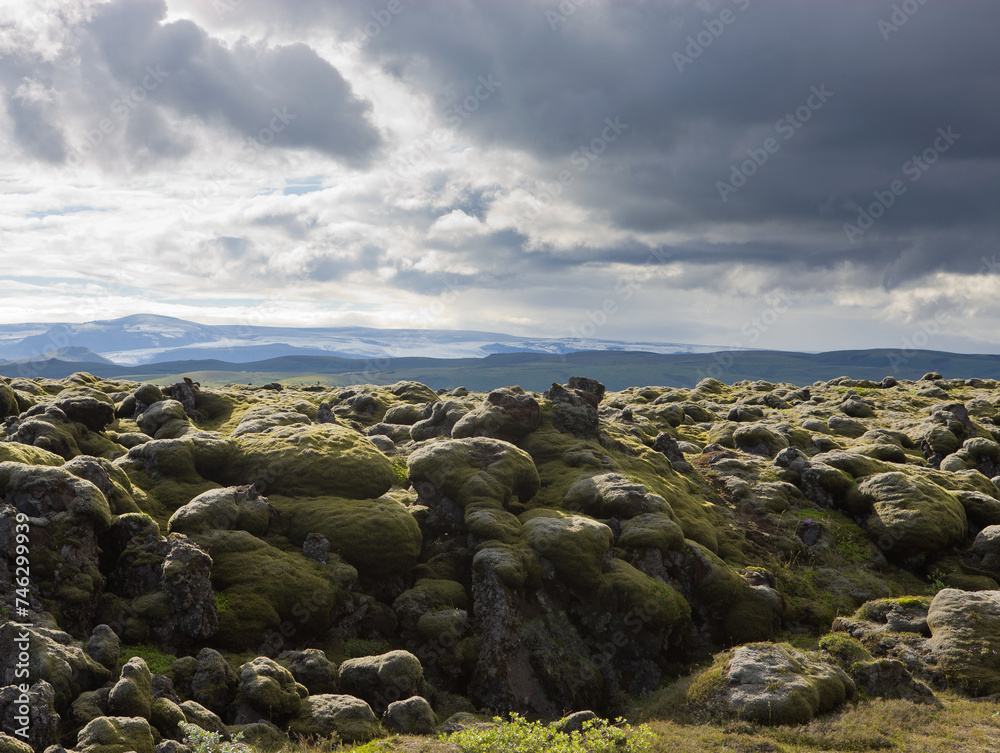 A large rocky landscape with a cloudy sky A large rocky landscape with a cloudy sky