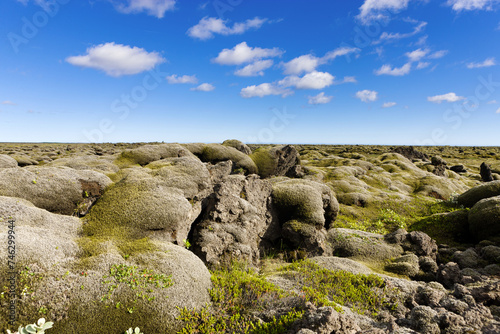 A rocky landscape with blue sky and clouds