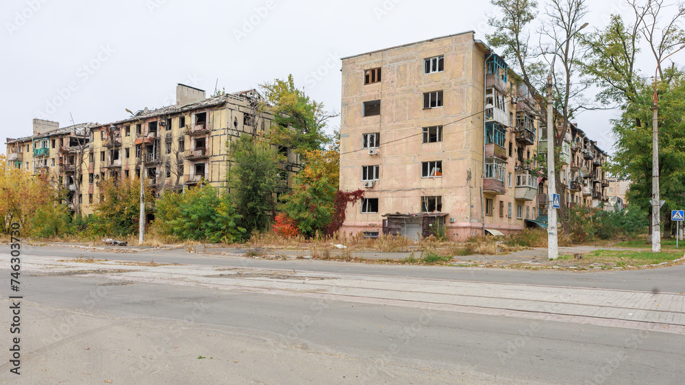 Closeup view of ruined facade of house in Mariupol.