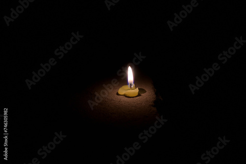 Closeup of melted green candle in dark.