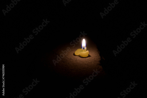 Closeup of melted green candle in dark.