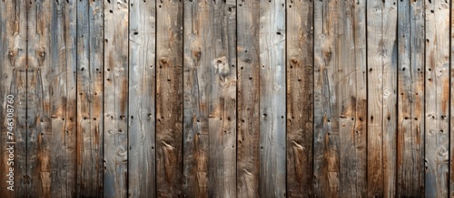 A photo showcasing a wooden fence made from weathered boards that were repurposed from a barn.