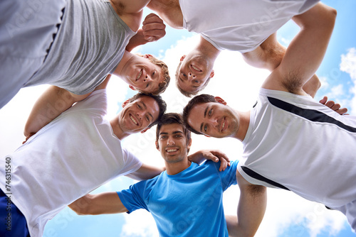Men, circle and portrait with sports in low angle for hug, support or teamwork at training in nature. People, group and happy to embrace in huddle, scrum or together for exercise, workout or fitness photo