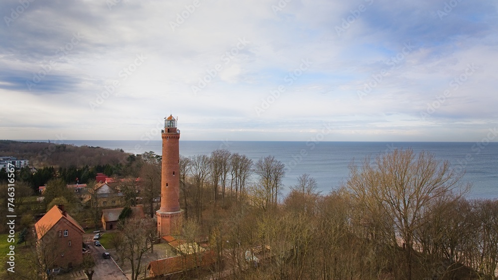 A drone captures Gąski beach, West Pomeranian Voivodeship, Poland, featuring a red brick lighthouse.