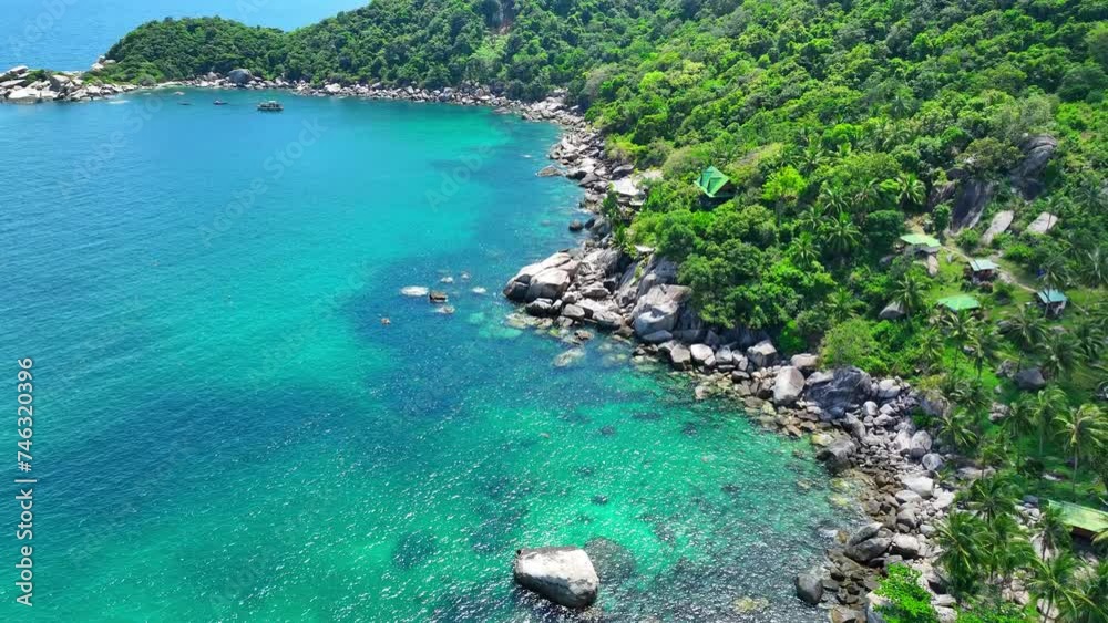 A secluded paradise adorned with lush greenery, pristine beaches, and azure waters, offering serenity and peace amidst nature's embrace. Flight over the ocean. Koh Tao, Southern Thailand. 4K UHD.
