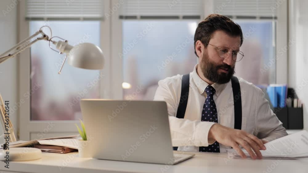 Office worker. Male office worker works, rearranges papers. Daily routine in workplace Office worker. Male office worker works, rearranges papers. Daily routine in workplace