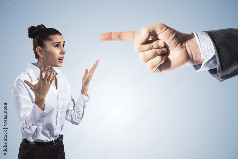 Abstract image of boss hand pointing at stressed businesswoman on light gray background. Bad job decision and mistake concept. Abstract image of boss hand pointing at stressed businesswoman on light gray background. Bad job decision and mistake concept.