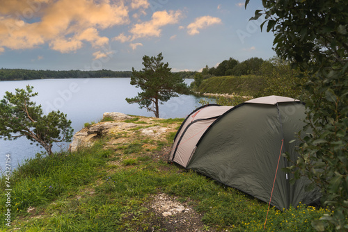 Camping with a tent in nature on the shore of Lake Rummu in summer.