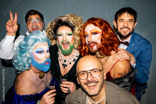Cheerful drag queens along with diverse men