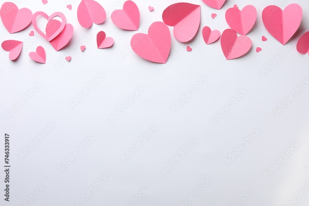 Pink paper hearts on white background, flat lay. Space for text
