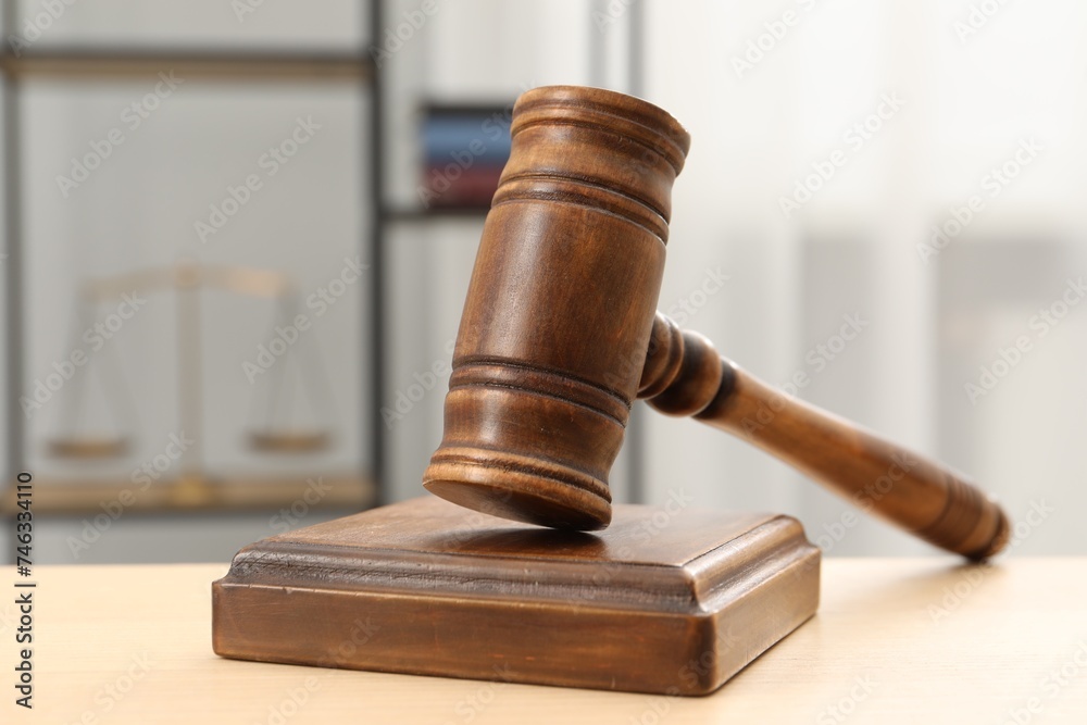 Wooden gavel and sound block on table indoors, closeup Wooden gavel and sound block on table indoors, closeup