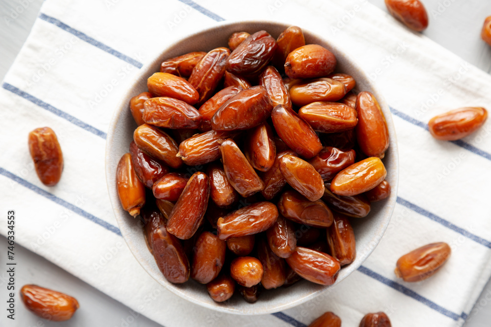 Organic Raw Date Fruit in a Bowl, overhead view. Flat lay, from above, top view. Organic Raw Date Fruit in a Bowl, overhead view. Flat lay, from above, top view.
