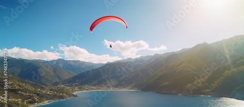 Bright and cheerful morning  a Paraglider takes off from a mountain slope in the Carpathian Mountains beneath which there is a river with flowing water.