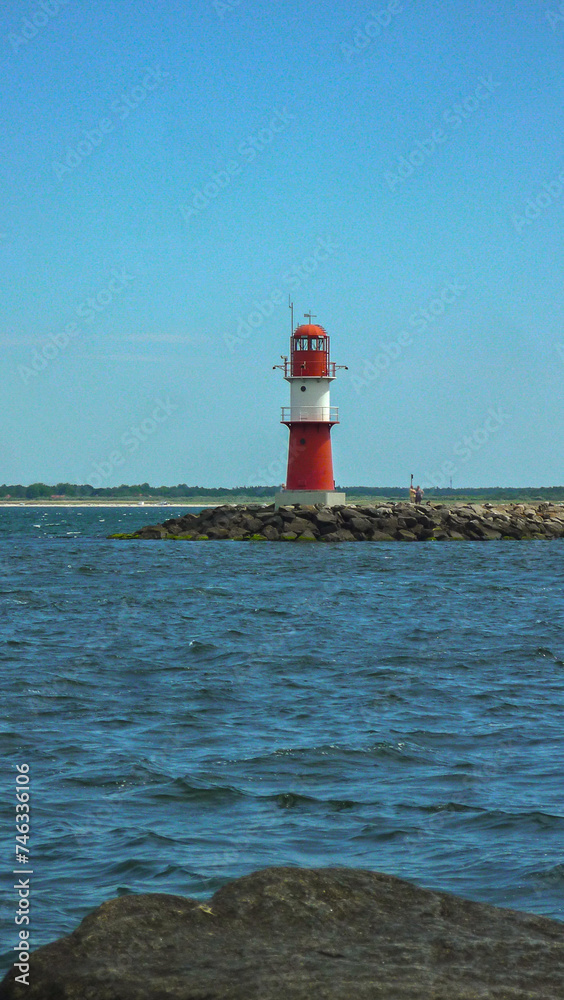 Sand dunes and maritime seascape coast view with lighthouse in Warnemunde Rostock, Germany at East Sea 