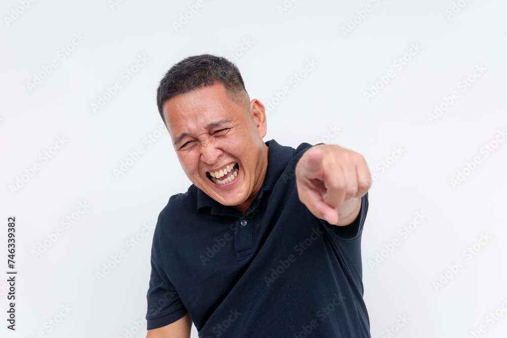 A middle-aged man laughing and pointing at someone off camera, making a mockery of someone, isolated on a white background. A middle-aged man laughing and pointing at someone off camera, making a mockery of someone, isolated on a white background.