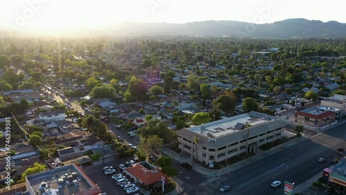 Los Angeles, California, USA - May 7, 2023: Sunset light shines on businesses in the urban core of downtown Canoga Park. photo