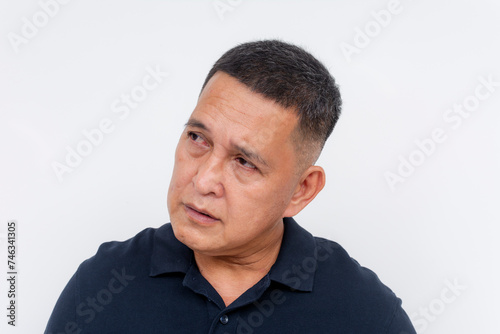 Portrait of a worried middle-aged Asian man looking aside. Wrinkles on forehead. Isolated on white background.