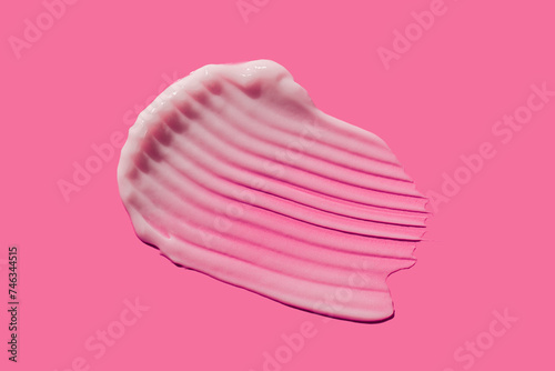 Cosmetic cream gel swatch isolated on pink background