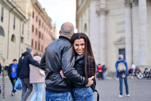 Happy Beautiful Tourists couple traveling at Rome, Italy, taking a selfie portrait at Piazza del Popolo.Visiting Italy - man and woman enjoying weekend vacation - Happy lifestyle concept 