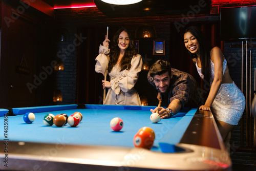 Cuadro en lienzo Young diversity group of people playing pool together with smile, enjoyment and fun