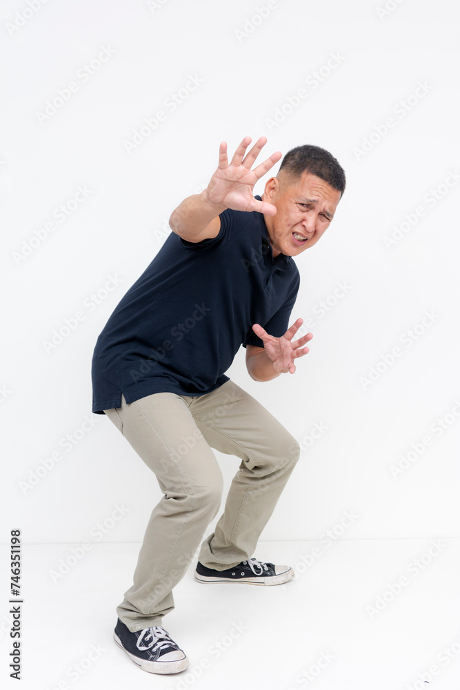Full body photo of a cowardly asian man in fear pleading for mercy and gesturing stop with his hand, expressing dread and panic, isolated on white. Full body photo of a cowardly asian man in fear pleading for mercy and gesturing stop with his hand, expressing dread and panic, isolated on white.