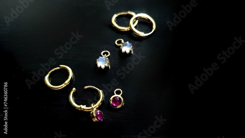 earring 18k Gold setting with gems stone on black background. Jewelry set for strore photo