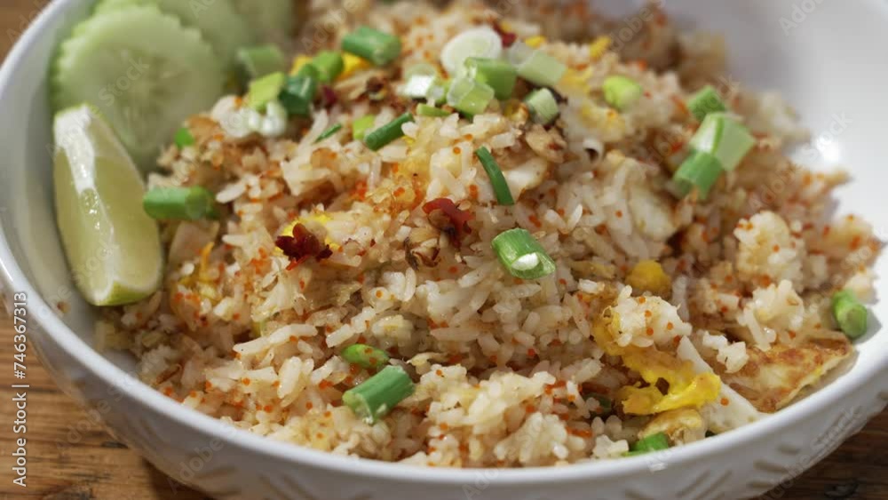 Plated dish of restaurant crab fried rice topped with green onions, close up slider 4K Plated dish of restaurant crab fried rice topped with green onions, close up slider 4K