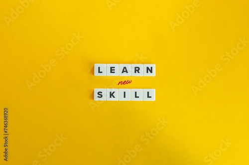 Learn New Skill Phrase. Concept of Upskilling, Reskilling, Acquiring Knowledge, Ability, or Technique, Developing Proficiency. Text on Block Letter Tiles on Yellow Background. photo