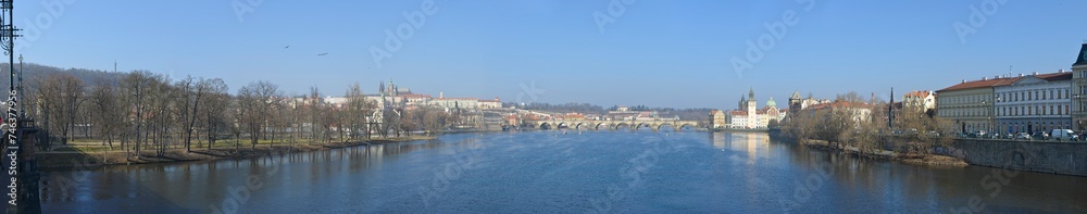 Panoramic view along Vltava river towards Charles Bridge, Prague, Czech.